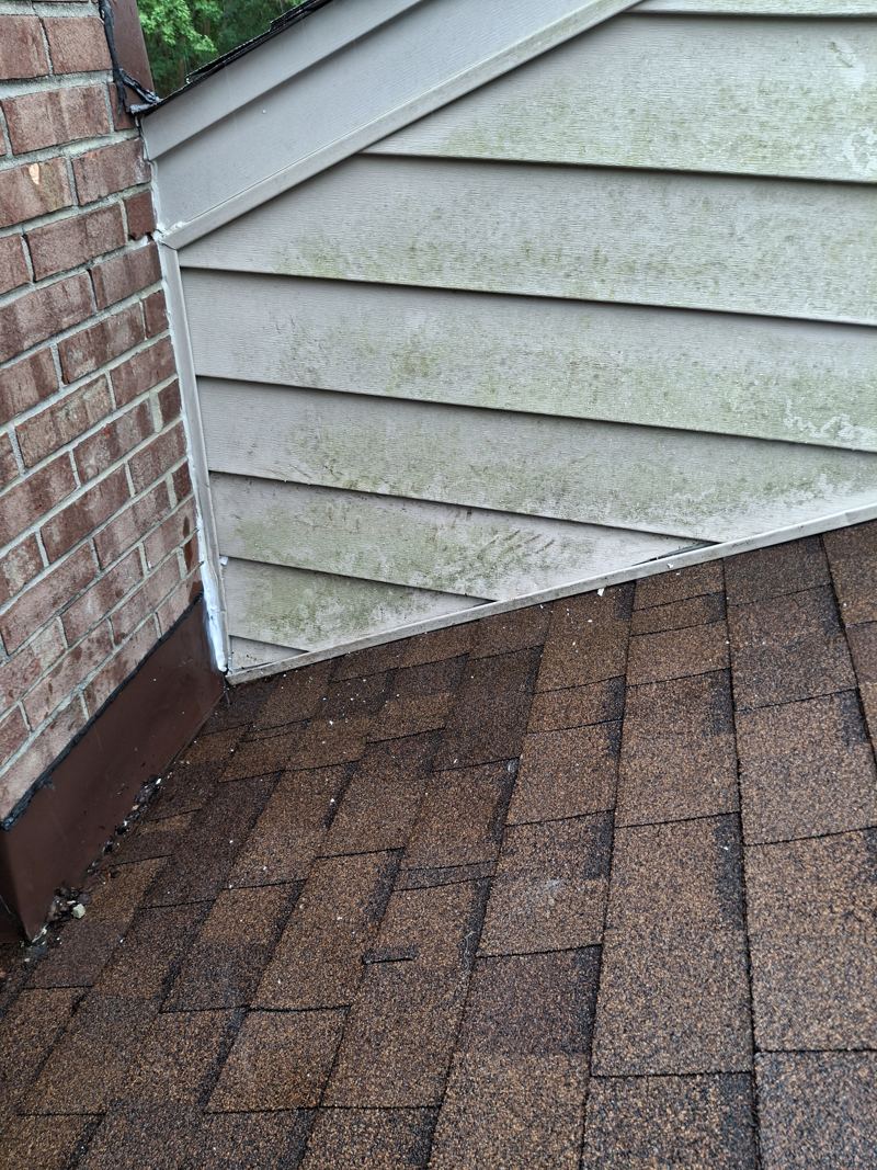 The same soffit corner refitted flush against the brick with no gap left